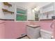 Bathroom featuring pink tile, dark trim, and a vintage sink at 1713 Wildwood Dr, Albemarle, NC 28001