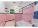 Pink tiled bathroom featuring a tub, shower, and vanity at 1713 Wildwood Dr, Albemarle, NC 28001