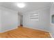 Bright bedroom features hardwood floors, a window, a closet, and light gray walls at 1713 Wildwood Dr, Albemarle, NC 28001