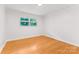 A clean bedroom featuring wood floors, white walls and a window at 1713 Wildwood Dr, Albemarle, NC 28001