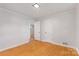 Clean and spacious bedroom with hardwood floors and an open doorway at 1713 Wildwood Dr, Albemarle, NC 28001