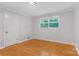 A clean bedroom with wood floors, closet, and natural light at 1713 Wildwood Dr, Albemarle, NC 28001