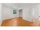 Bright bedroom features hardwood floors, a window, a closet, and white walls at 1713 Wildwood Dr, Albemarle, NC 28001