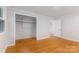 A clean bedroom with wood floors, a closet and a bright window at 1713 Wildwood Dr, Albemarle, NC 28001