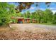 A long view of the home's brick exterior, long driveway, and covered parking area at 1713 Wildwood Dr, Albemarle, NC 28001