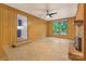Living room features wood paneling, brick fireplace, and a large window with backyard views at 1713 Wildwood Dr, Albemarle, NC 28001