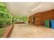 Wide view of the covered back patio featuring brick walls, brick surround, a white roof, and forest views at 1713 Wildwood Dr, Albemarle, NC 28001