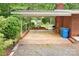 View of the home's covered patio showing a brick floor, brick surround, and ample room for outdoor furniture at 1713 Wildwood Dr, Albemarle, NC 28001