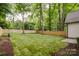 Expansive backyard with a new wooden fence, lush green lawn, and surrounding trees at 1807 Arnold Dr, Charlotte, NC 28205