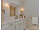 Stylish half bathroom features white marble countertops, gold fixtures and mirror, and neutral wall paint at 1807 Arnold Dr, Charlotte, NC 28205