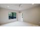 Spacious bedroom featuring a ceiling fan, ensuite access and a bright window, perfect for comfort and relaxation at 1807 Arnold Dr, Charlotte, NC 28205