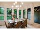 Elegant dining room filled with natural light, modern furnishings, and views of the lush backyard at 1807 Arnold Dr, Charlotte, NC 28205