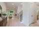 Inviting entryway featuring modern stairs and a glimpse into the stylish living room, creating a warm welcome at 1807 Arnold Dr, Charlotte, NC 28205