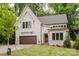 Beautiful two-story home featuring a modern design, attached garage, and professionally landscaped front yard at 1807 Arnold Dr, Charlotte, NC 28205