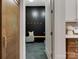 A stylish mudroom with a wooden bench, black paneling, and stone tile flooring at 1807 Arnold Dr, Charlotte, NC 28205
