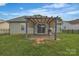 A cozy backyard with a pergola-covered patio, ideal for outdoor relaxing and dining at 2008 Taras Trace Dr, Statesville, NC 28625