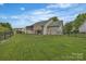 View of a fenced backyard with a covered patio providing an inviting outdoor living space at 2008 Taras Trace Dr, Statesville, NC 28625