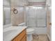 Bathroom featuring tile flooring, a wood vanity, white toilet, and a bathtub with shower at 2008 Taras Trace Dr, Statesville, NC 28625