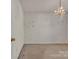 Bedroom with neutral walls, plush carpeting, and a chandelier at 2008 Taras Trace Dr, Statesville, NC 28625