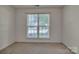Bedroom with neutral walls, plush carpeting, and natural light from a window at 2008 Taras Trace Dr, Statesville, NC 28625