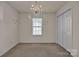 Bedroom with neutral walls, plush carpeting, a chandelier, and a window at 2008 Taras Trace Dr, Statesville, NC 28625