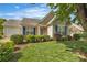 Charming single-story home boasts a well-manicured lawn, neat landscaping, and blue shutters at 2008 Taras Trace Dr, Statesville, NC 28625