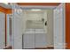 A laundry closet features a side-by-side washer and dryer with wire shelving at 2008 Taras Trace Dr, Statesville, NC 28625