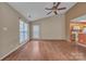 Well lit living room with ceiling fan, and view into the kitchen, adjacent to the dining area at 2008 Taras Trace Dr, Statesville, NC 28625