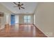 Bright living room featuring hardwood floors, a ceiling fan, and natural light from the front window at 2008 Taras Trace Dr, Statesville, NC 28625