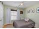 Cozy bedroom features light green walls, a ceiling fan, and a window offering natural light at 206 Summey Barker Dr, Dallas, NC 28034