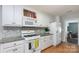 Well-lit kitchen featuring white cabinets, stainless appliances, and a stylish backsplash at 206 Summey Barker Dr, Dallas, NC 28034