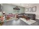 Comfortable living room with a gray sectional sofa, wooden coffee table, and bright windows at 206 Summey Barker Dr, Dallas, NC 28034