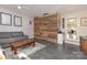 Modern living room with gray sofa, wooden coffee table, accent wall, and sleek flooring at 206 Summey Barker Dr, Dallas, NC 28034