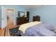 Comfortable main bedroom boasts a dark wood dresser, blue walls, and a well-sized closet at 206 Summey Barker Dr, Dallas, NC 28034