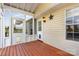 Enclosed sunroom featuring wood flooring, lots of windows, and a dog door at 206 Summey Barker Dr, Dallas, NC 28034