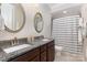 Well-lit bathroom with dual sinks, granite countertops, a shower/tub, and neutral colors at 209 Helton Ln, Fort Mill, SC 29708