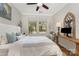 Well lit bedroom with natural light, ceiling fan, queen bed and a wood desk at 209 Helton Ln, Fort Mill, SC 29708