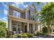 Beautiful two-story home with a covered front porch, decorative columns, and freshly manicured landscaping at 209 Helton Ln, Fort Mill, SC 29708