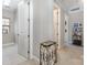 Bright hallway with white trim and open doorways leads to a carpeted area with built-in shelving at 209 Helton Ln, Fort Mill, SC 29708