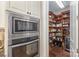 Pantry and built-in stainless steel microwave and oven are conveniently located in the kitchen at 209 Helton Ln, Fort Mill, SC 29708