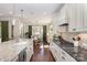 Bright kitchen featuring white cabinetry, granite countertops, stainless steel appliances and open access to dining at 209 Helton Ln, Fort Mill, SC 29708
