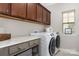 Bright laundry room featuring front load washer and dryer, quartz countertop and neutral color palette at 209 Helton Ln, Fort Mill, SC 29708