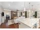Open concept living space with a stone fireplace, hardwood floors and large kitchen island at 209 Helton Ln, Fort Mill, SC 29708