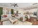 Open-concept living room flowing into a modern kitchen, with hardwood floors and stylish furnishings at 209 Helton Ln, Fort Mill, SC 29708