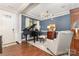 Elegant living room with hardwood floors, a grand piano, and stylish decor with blue accent wall at 209 Helton Ln, Fort Mill, SC 29708
