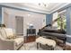 Comfortable living room with a piano, an armchair and patterned accent wall for a touch of sophistication at 209 Helton Ln, Fort Mill, SC 29708