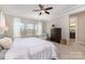 Comfortable bedroom featuring large windows, ceiling fan, dark dresser, and easy access to a full bath at 209 Helton Ln, Fort Mill, SC 29708