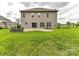 Spacious backyard view with a fire pit, patio, and lush green lawn, creating an inviting outdoor space at 2369 Baxter Se Pl, Concord, NC 28025