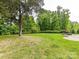 A sprawling backyard offers a fire pit, mature trees, and endless possibilities at 2369 Baxter Se Pl, Concord, NC 28025