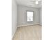 A bright bedroom features neutral carpeting and a window with mini blinds for natural light at 2369 Baxter Se Pl, Concord, NC 28025